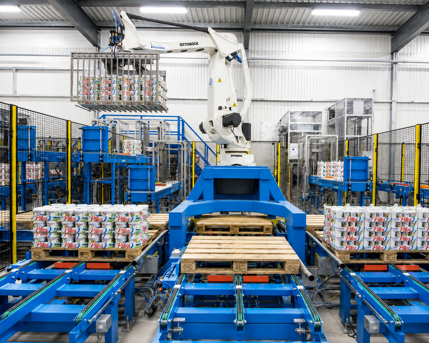 Industrial palletizing robot handling packaged products in a production workshop