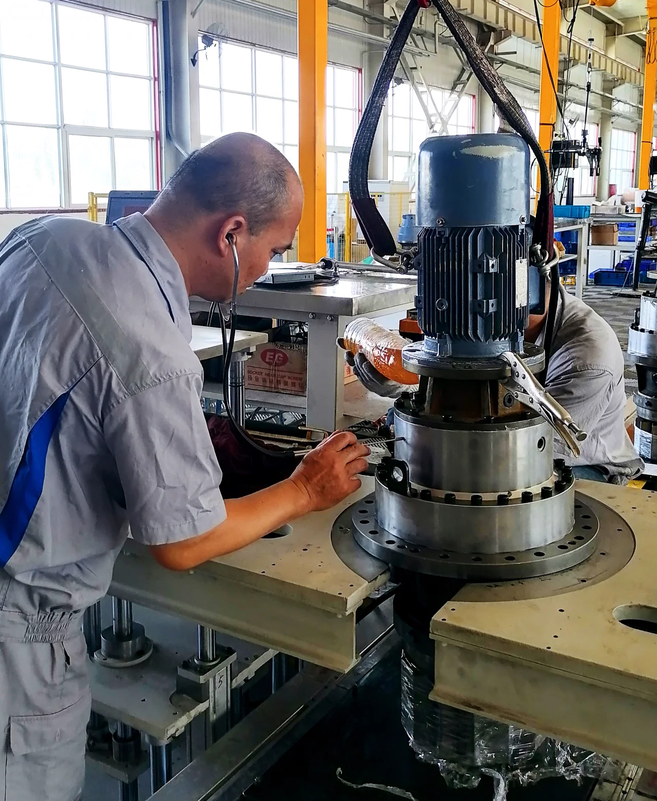 Technicians inspecting and adjusting industrial equipment on site